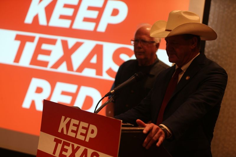 Republican state Reps. Todd Hunter, left, and A.J. Louderback stand before a projector emblazoned with the words "Keep Texas Red" during a news conference at the downtown Holiday Inn in Corpus Christi on June 26, 2026. The Republicans held the news conference to coincide with the Texas Democratic Convention taking place in Corpus Christi.
