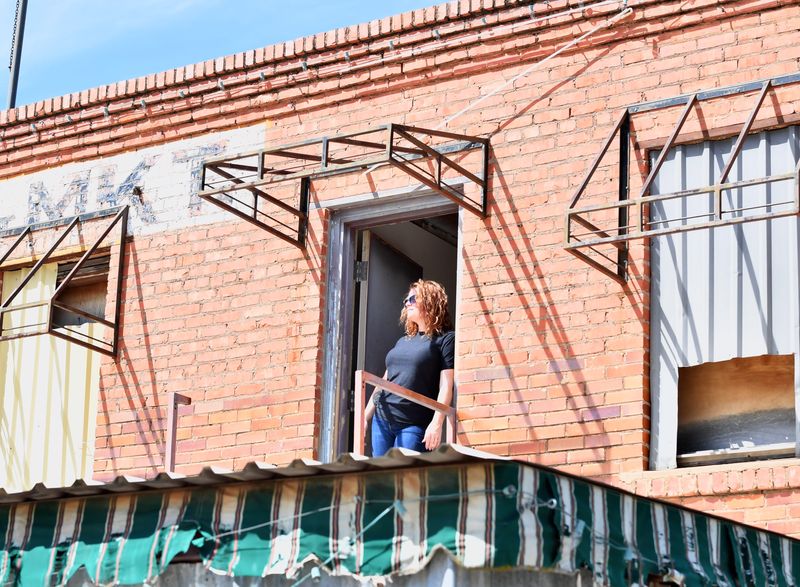Developer Devonie Hutchinson stands in the doorway on the second floor of the former Neon Spur at 200 N. Burnett St. in Wichita Falls on July 1. She is likely standing where outlaw Bonnie Parker stood nearly a century ago.