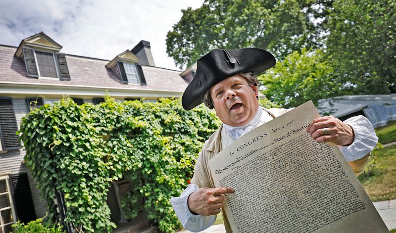 John Adams re-enactor Michael LePage reads the Declaration of Independence in front of the Adams homestead, known as Peace Field, in Quincy on Thursday July 2, 2026. The Adams National Historic Park in Quincy conducted a "Continental Congress" as was done 250 years ago to ratify the Declaration of Independence, which was signed two days later on July 4th in Philadelphia. The declaration was co-written by John Adams, of Quincy, and Thomas Jefferson.