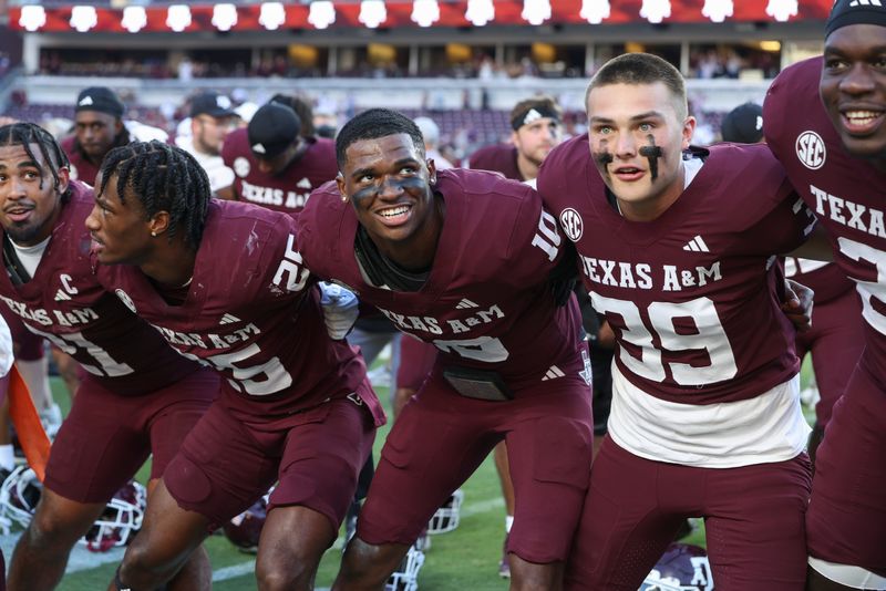 Sep 27, 2025; College Station, Texas, USA; Texas A&M Aggies quarterback Marcel Reed (10) celebrates with teammates after the game against the Auburn Tigers at Kyle Field. Mandatory Credit: Troy Taormina-Imagn Images