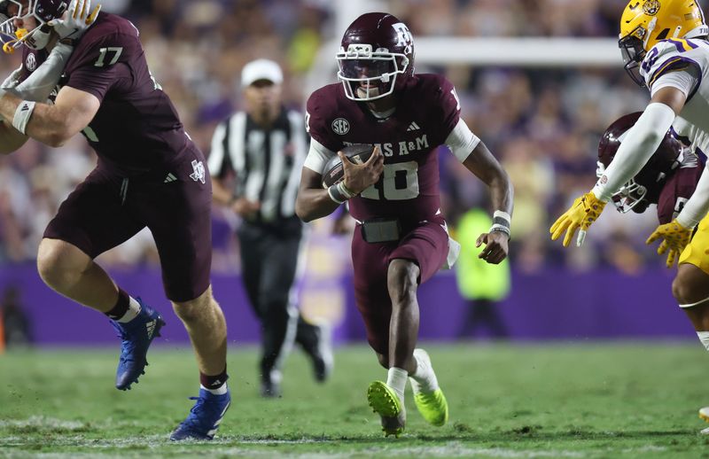 Oct 25, 2025; Baton Rouge, Louisiana, USA; Texas A&M Aggies quarterback Marcel Reed (10) scrambles during the second half against the Louisiana State Tigers at Tiger Stadium. Mandatory Credit: Stephen Lew-Imagn Images