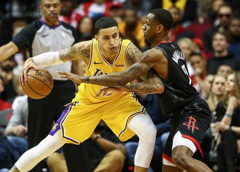 Jan 19, 2019; Houston, TX, USA; Los Angeles Lakers forward Kyle Kuzma (0) controls the ball as Houston Rockets forward James Nunnally (21) defends during the first quarter at Toyota Center. Mandatory Credit: Troy Taormina-USA TODAY Sports