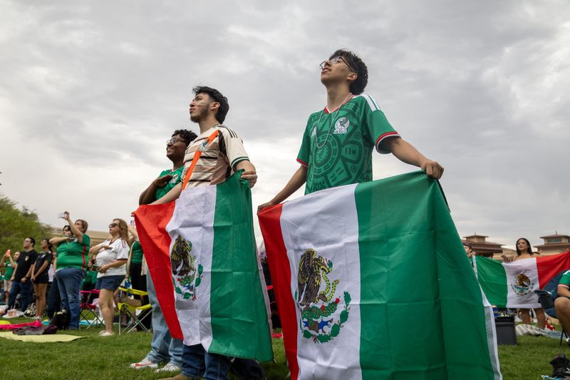 Fans wave Mexican flags as they cheer on El Tri before kickoff during the Mexico vs. England World Cup Round of 16 watch party at UTEP’s Centennial Plaza on Sunday, July 5, 2026.