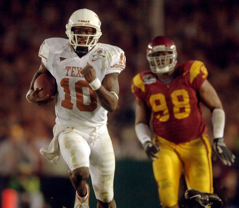Jan 4, 2006; Pasadena, CA, USA; Texas Longhorns quarterback (10) Vince Young runs past Southern California Trojans defensive tackle (98) LaJuan Ramsey during the 4th quarter of the Rose Bowl Game at the Rose Bowl in Pasadena, California. Mandatory Credit: Mark J. Rebilas-USA TODAY Sports Copyright © 2006 Mark J. Rebilas