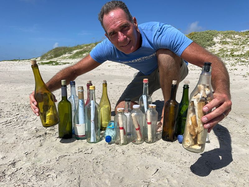 Jace Tunnell with some of his messages in bottles found over the years.