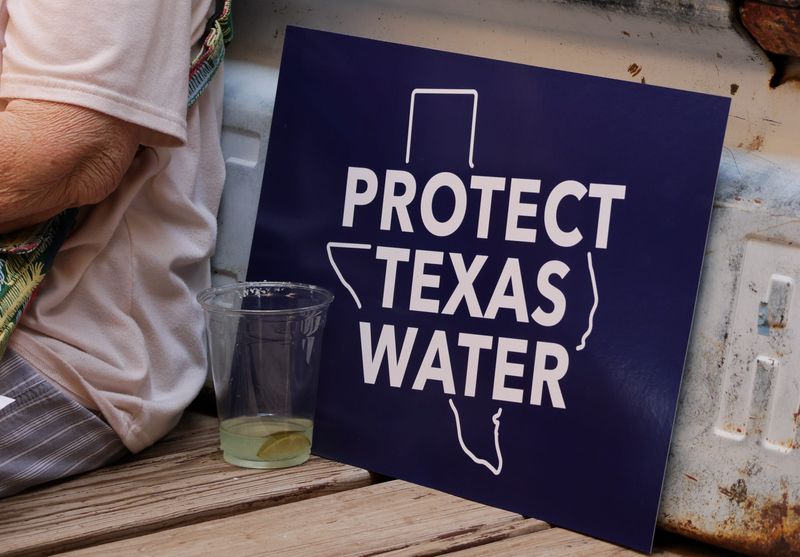 An anti-data center sign that reads "Protect Texas Water" sits on a bench at The Garden, at 1801 Buddy Holly Ave, during the South Plains Swing Tour on July 18, 2026, in Lubbock, Texas.