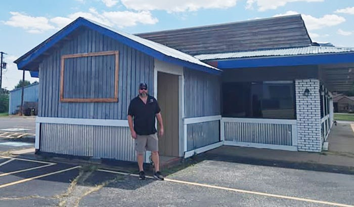 Jake Russey stands in front of former cafe in Burkburnett he and his wife, Hillary, are converting into Gringo's Texas BBQ.