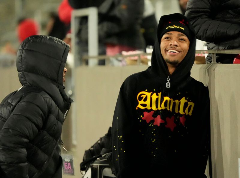 Dec 5, 2025; Birmingham, AL, USA; KJ Lacey smiles as he talks to fans on the sidelines at Protective Life Stadium in the AHSAA 6A State Championship game.