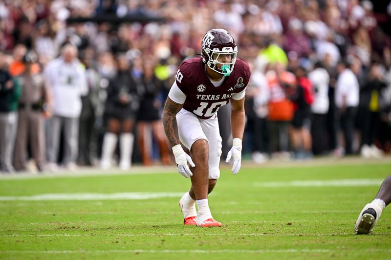 Dec 20, 2025; College Station, TX, USA; Texas A&M Aggies defensive end Marco Jones (10) lines up during the game between the Aggies and the Hurricanes at Kyle Field. Mandatory Credit: Jerome Miron-Imagn Images