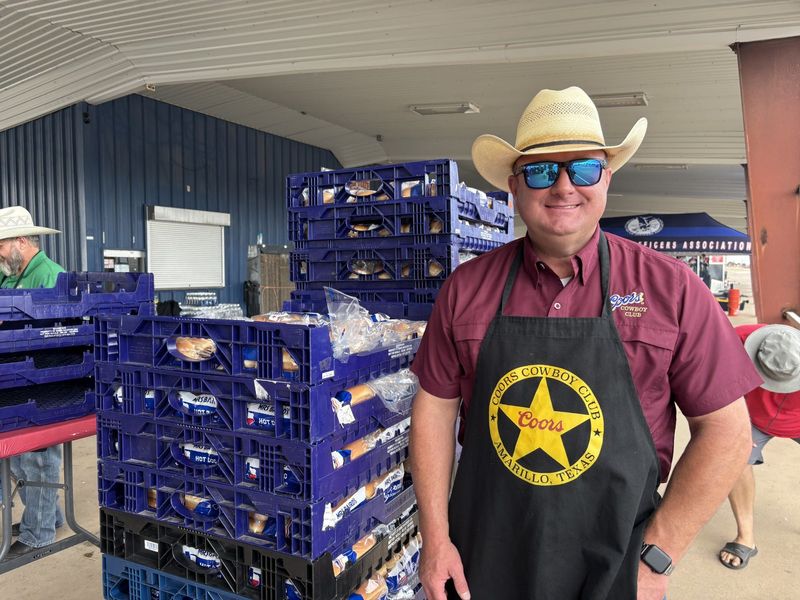 Casey Dawson with the Coors Cowboy Club lends a hand in cooking for the July 31 fundraiser to help out Sterling Shelton, a young Texas Ranger with the Texas Department of Safety who was diagnosed last year with an invasive form of brain cancer. All proceeds from Friday's event will go to Shelton and his wife and children.