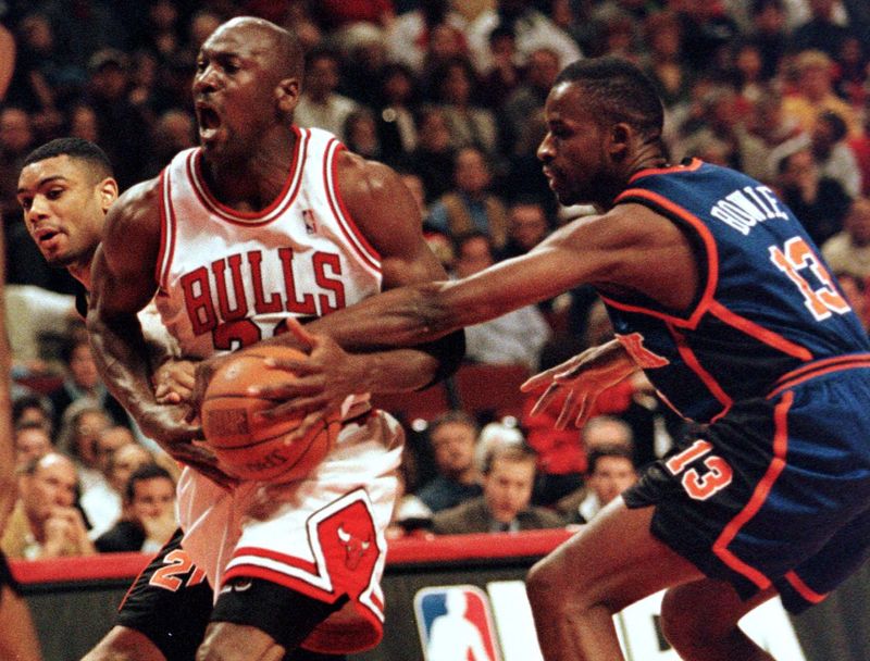 Chicago Bulls' Michael Jordan gets double-teamed by New York Knicks' Allan Houston (L) and Anthony Bowie during first quarter NBA action, April 18 at the United Center in Chicago.

REUTERS