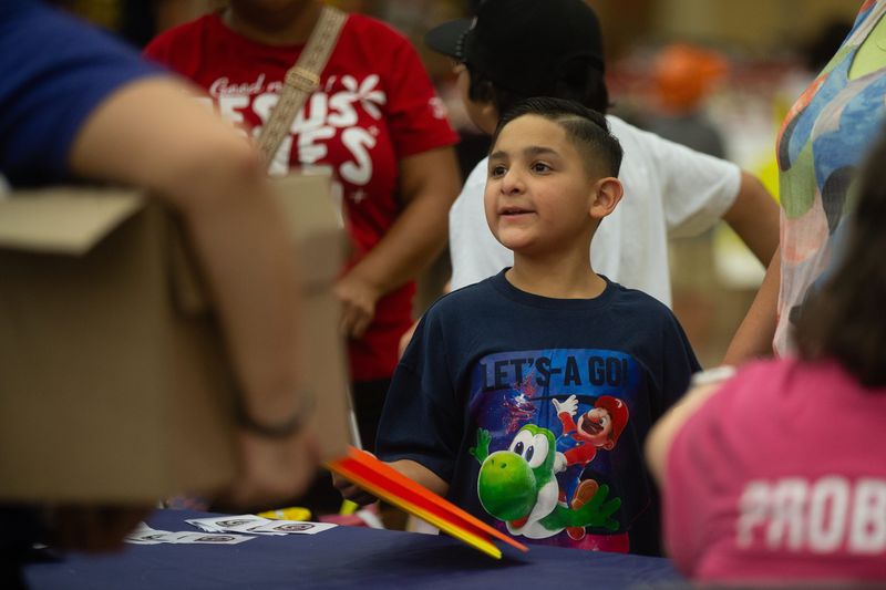Abram James, 8, thanks a vendor for free folders at the Corpus Christi Police Department's annual Operation Safe Return at the Hilliard Center in Corpus Christi, Texas, on Aug. 1, 2026.