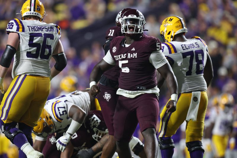 Oct 25, 2025; Baton Rouge, Louisiana, USA; Texas A&M Aggies defensive tackle DJ Hicks (5) celebrates after a play during the second half against the Louisiana State Tigers at Tiger Stadium. Mandatory Credit: Stephen Lew-Imagn Images