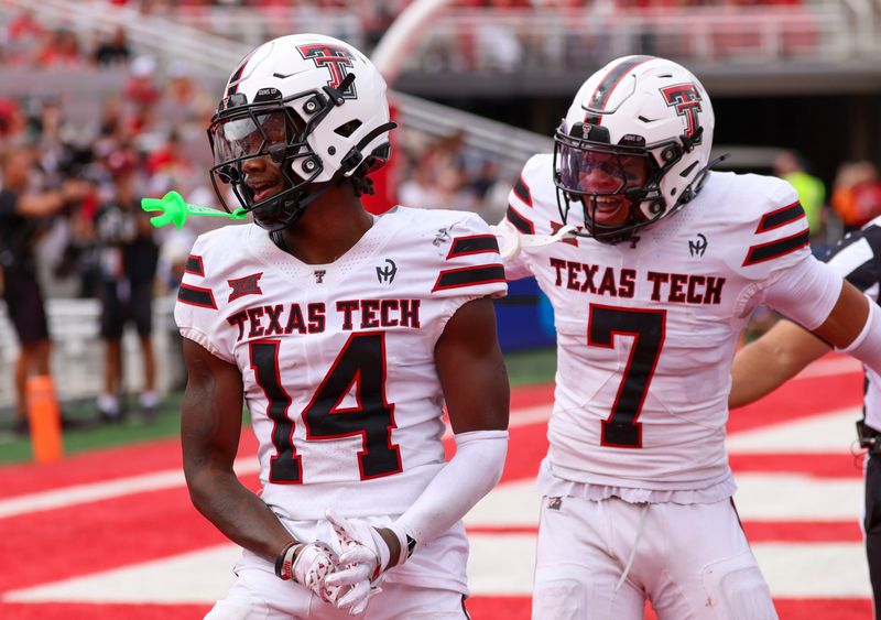Sep 20, 2025; Salt Lake City, Utah, USA; Texas Tech Red Raiders defensive back Brice Pollock (14) and defensive back Brenden Jordan (7) react to a defensive stop against the Utah Utes during the third quarter at Rice-Eccles Stadium. Mandatory Credit: Rob Gray-Imagn Images