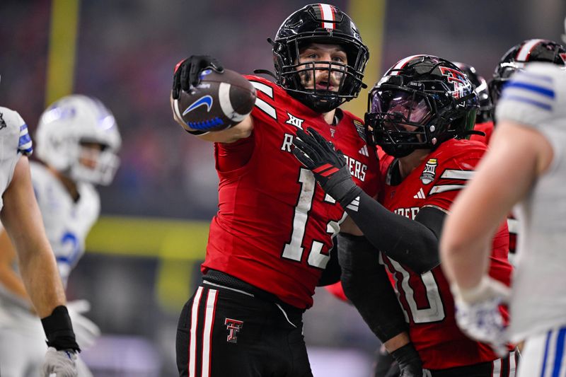 Dec 6, 2025; Arlington, TX, USA; Texas Tech Red Raiders linebacker Ben Roberts (13) and linebacker Jacob Rodriguez (10) celebrates an interception during the game between the Red Raiders and the Cougars at AT&T Stadium. Mandatory Credit: Jerome Miron-Imagn Images