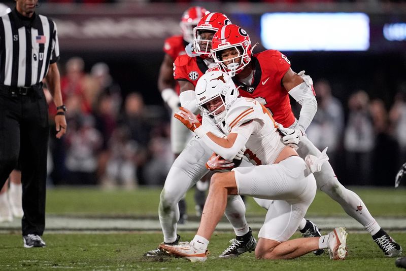 Nov 15, 2025; Athens, Georgia, USA; Georgia Bulldogs defensive back Daylen Everette (6) tackles Texas Longhorns quarterback Arch Manning (16) in the second half at Sanford Stadium. Mandatory Credit: Dale Zanine-Imagn Images