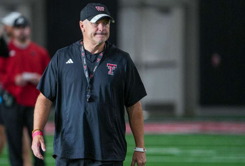 Texas Tech head coach Joey McGuire walks the field during football practice, Wednesday, Aug. 5, 2026, at the Womble Football Center.