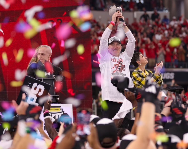 Texas Tech head coach Joey McGuire lifts the trophy as confetti starts to fall after the Red Raiders beat BYU 34-7 in Big 12 Championship football game, Saturday, Nov. 6, 2025, at AT&T Stadium in Arlington.