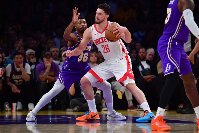 Apr 29, 2026; Los Angeles, California, USA; Houston Rockets center Alperen Sengun (28) moves the ball against Los Angeles Lakers guard Marcus Smart (36) during the first half in game five of the first round of the 2026 NBA Playoffs at Crypto.com Arena. Mandatory Credit: Gary A. Vasquez-Imagn Images