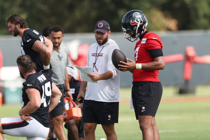 Jul 30, 2026; Houston, Texas, USA;  Houston Texans offensive coordinator Nick Caley talks with quarterback C.J. Stroud (7) during training camp at Houston Methodist Training Center. Mandatory Credit: Troy Taormina-Imagn Images