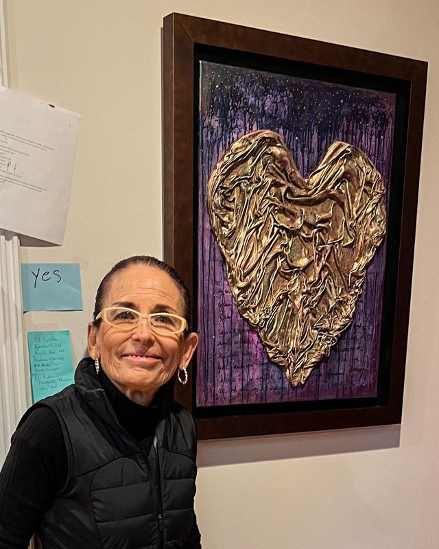 El Paso artist Carmen Navar is shown with a heart artwork she made from one of her late husband's shirts.