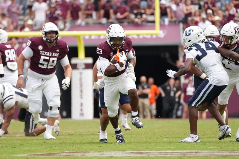 Sep 6, 2025; College Station, Texas, USA; Texas A&M Aggies running back Jamarion Morrow (23) runs the football during the second half against the Utah State Aggies at Kyle Field. Mandatory Credit: Sean Thomas-Imagn Images