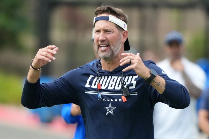 Aug 11, 2026; Woodland Hills, CA, USA; Dallas Cowboys head coach Brian Schottenheimer reacts during a joint practice against the Los Angeles Rams at the Rams Practice Facility. Mandatory Credit: Kirby Lee-Imagn Images
