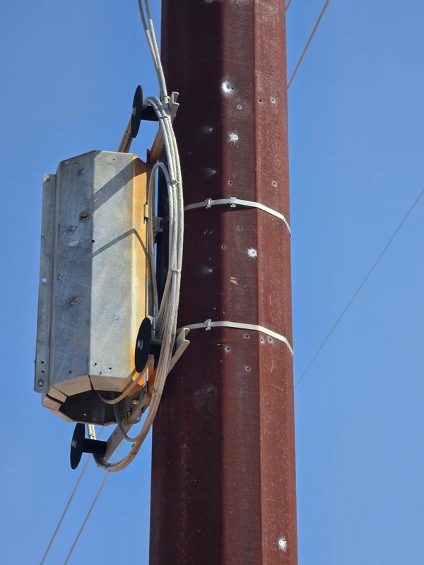 Vandalism targeting electric transmission structures and fiber optic communications.