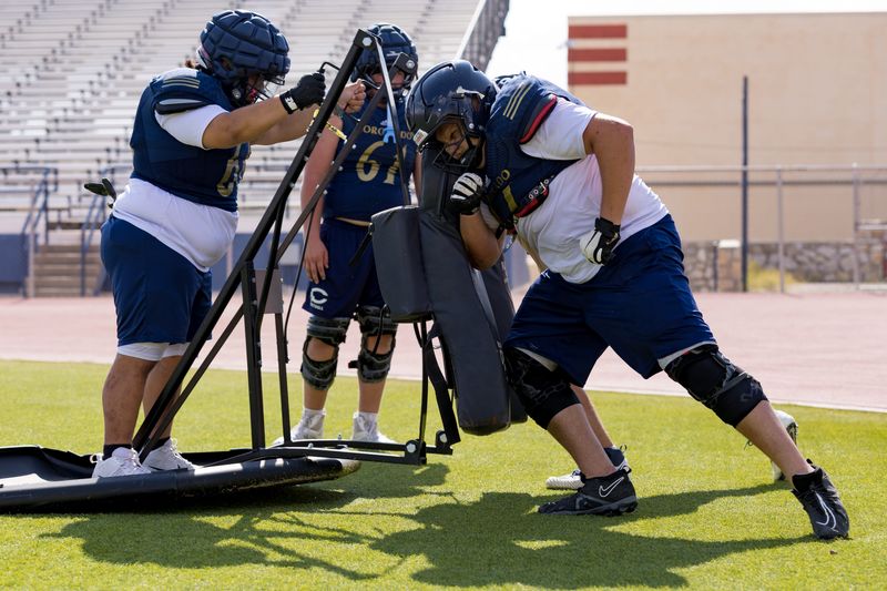 Coronado football players work in a blocking drill during practice Tuesday, Aug. 11, 2026, at Coronado High School in West El Paso, Texas.