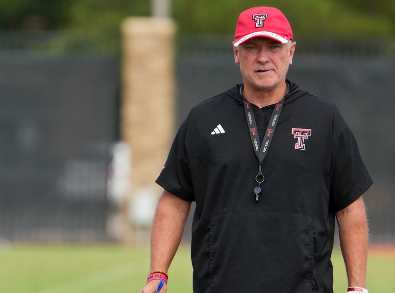 Texas Tech head coach Joey McGuire walks the field during football practice, Tuesday, Aug. 11, 2026, at the Womble Football Center.