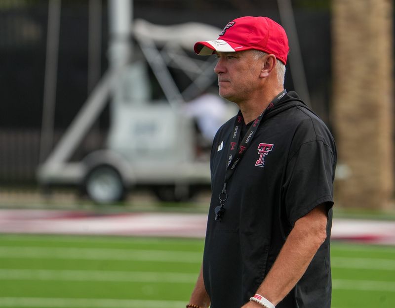 Texas Tech head coach Joey McGuire walks the field during football practice, Tuesday, Aug. 11, 2026, at the Womble Football Center.