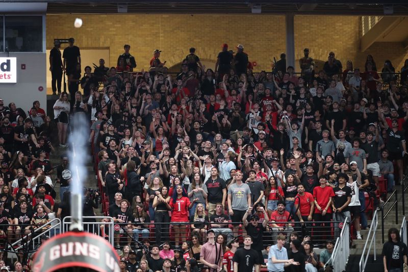 Mar 3, 2026; Lubbock, Texas, USA;  The Texas Tech Red Raiders student body tries to catch t-shirts shot from a canon in the second half of the game against the TCU Horned Frogs at United Supermarkets Arena. Mandatory Credit: Michael C. Johnson-Imagn Images