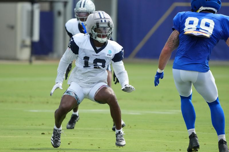 Dallas Cowboys safety Caleb Downs (13) defends against Los Angeles Rams tight end Tyler Higbee (89) during a joint practice at the Rams Practice Facility.