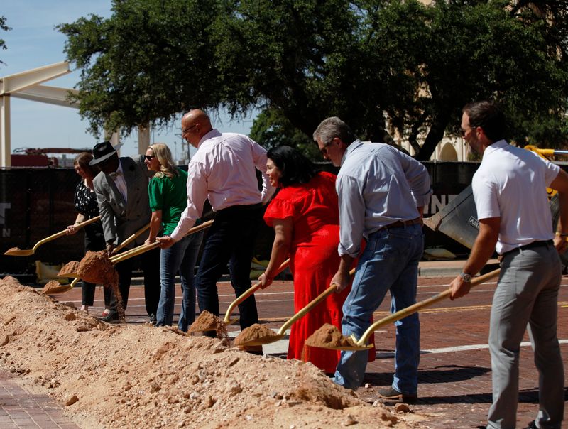 Lubbock city council members move dirt piled on Broadway near the Avenue M intersection during a groundbreaking ceremony for the reconstruction of a portions of Broadway from Avenues Q to E.