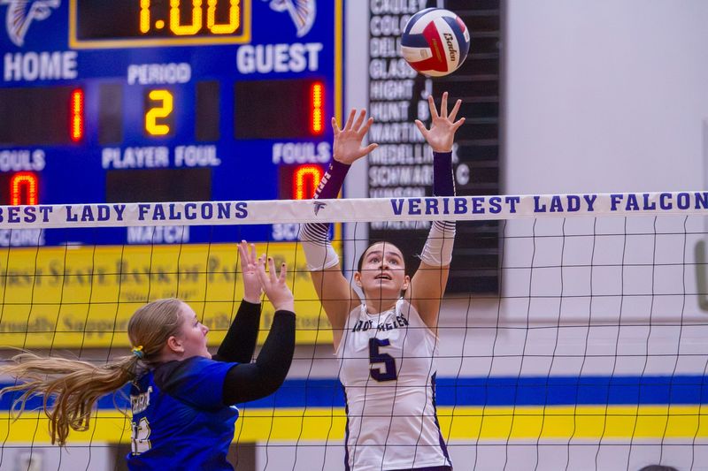 Sterling City volleyball's Cristina Geary (5) attempts to block a hit from Veribest's Kenzie Gilly (22) in the Falcon Fest Tournament at Veribest High School on Saturday, Aug. 15, 2026.