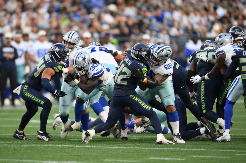 Aug 15, 2026; Seattle, Washington, USA; Dallas Cowboys running back Israel Abanikanda (30) carries the ball against the Seattle Seahawks during the second half at Lumen Field. Mandatory Credit: Steven Bisig-Imagn Images