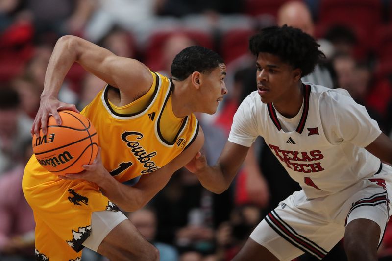 Nov 30, 2025; Lubbock, Texas, USA;  Wyoming Cowboys guard Damarion Dennis (1) keeps the ball from Texas Tech Red Raiders guard Christian Anderson (4) in the first half at United Supermarkets Arena. Mandatory Credit: Michael C. Johnson-Imagn Images