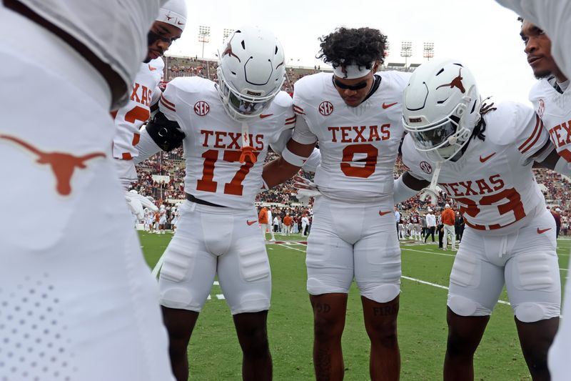 Oct 25, 2025; Starkville, Mississippi, USA; Texas Longhorns defensive backs Xavier Filsaime (17), Jonah Williams (9) and Jordon Johnson-Rubell (23) huddle up during warm ups prior to the game against the Mississippi State Bulldogs at Davis Wade Stadium at Scott Field. Mandatory Credit: Petre Thomas-Imagn Images