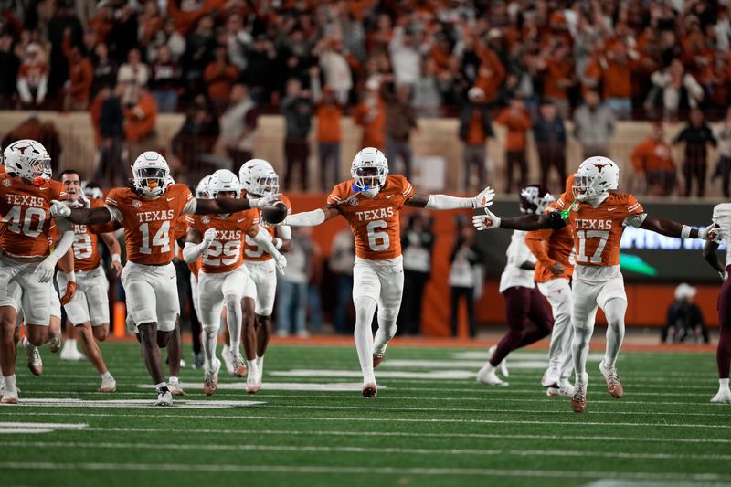 Nov 28, 2025; Austin, Texas, USA; Texas Longhorns defensive back Kobe Black (6) and teammates react after making an interception during the second half against the Texas A&M Aggies at Darrell K Royal-Texas Memorial Stadium. Mandatory Credit: Scott Wachter-Imagn Images