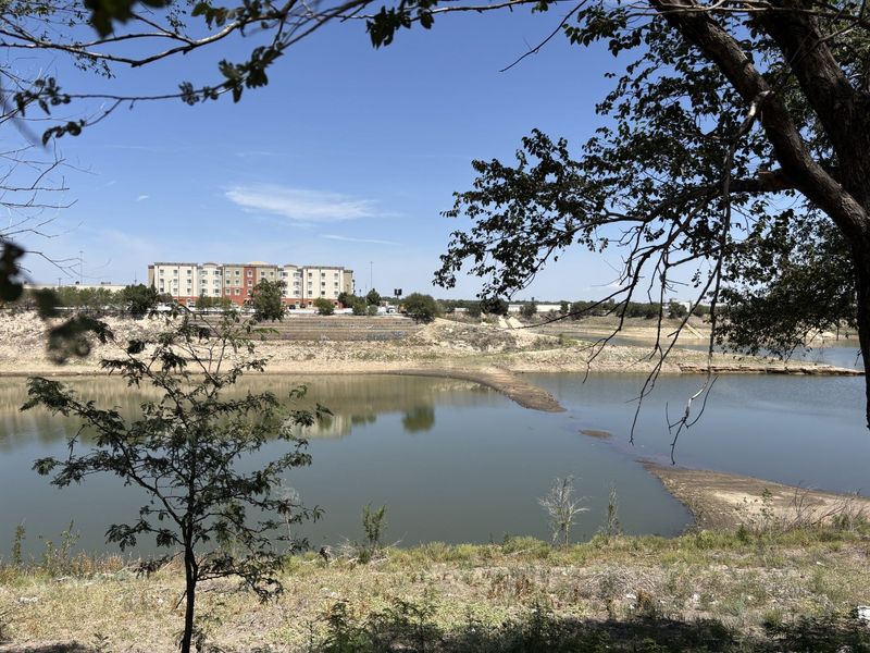 Once spilling over its banks, Lawrence Lake now has receded into a smaller pond as the lingering drought continues in this area, causing the city to enact Phase 1 of the Drought Contingency Plan as of Aug. 17.