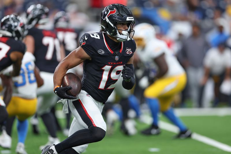 Aug 13, 2026; Houston, Texas, USA;  Houston Texans wide receiver Xavier Hutchinson (19) runs with the ball during the game against the Los Angeles Chargers at Reliant Stadium. Mandatory Credit: Troy Taormina-Imagn Images
