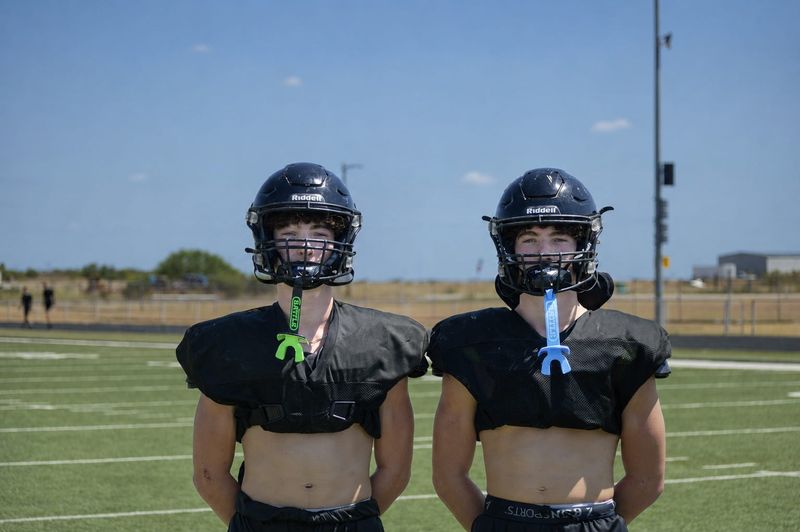 Reegan and Tanner Deerinwater pose for a photo at practice on Aug. 18, 2026 in Archer City.