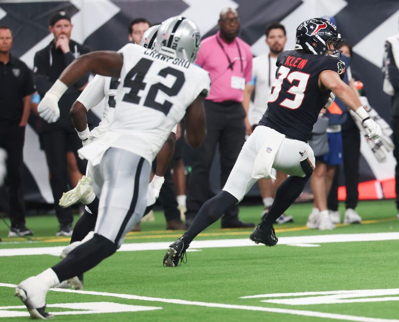 Aug 20, 2026; Houston, Texas, USA;  Houston Texans tight end Marlin Klein (83) runs after the catch against Las Vegas Raiders defensive end Keyron Crawford (42) in the first half at Reliant Stadium.  Mandatory Credit: Thomas Shea-Imagn Images