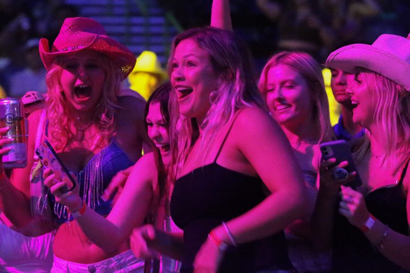 Attendees at Corpus Christi's 2022 Buc Days Rodeo Concert Series cheer and sing along with rapper Flo Rida at the American Bank Center Wednesday, May 11, 2022.