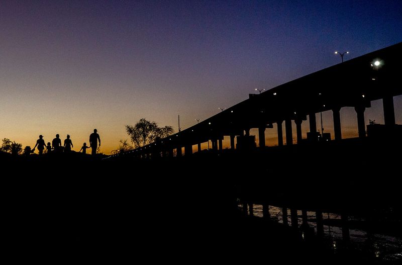 Haitian migrants cross the Rio Grande from Ciudad Juarez, Mexico to El Paso, Texas on May 17, 2022. The migrants evaded Mexican National Guard and quickly crossed the river embankment and turned themselves into Customs and Border Protection officers on the U.S. side of the international border.