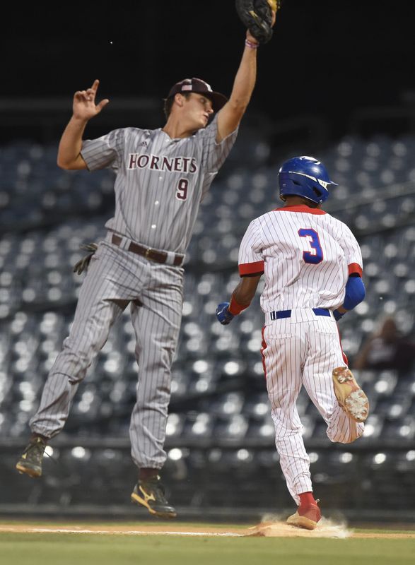 Neshoba Central's Bryceton Spencer is safe at first as East Central's Hollis Porter has to reach to catch a high throw during the 5A MHSAA Baseball Championship at Trustmark Park in Pearl, Miss., Thursday, May 26, 2022.