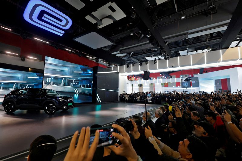 FILE PHOTO: Visitors and media cameramen film Maruti Suzuki's first EV, the e Vitara SUV on display at India's five-day auto show in New Delhi, India, January 17, 2025. REUTERS/Priyanshu Singh/File Photo
