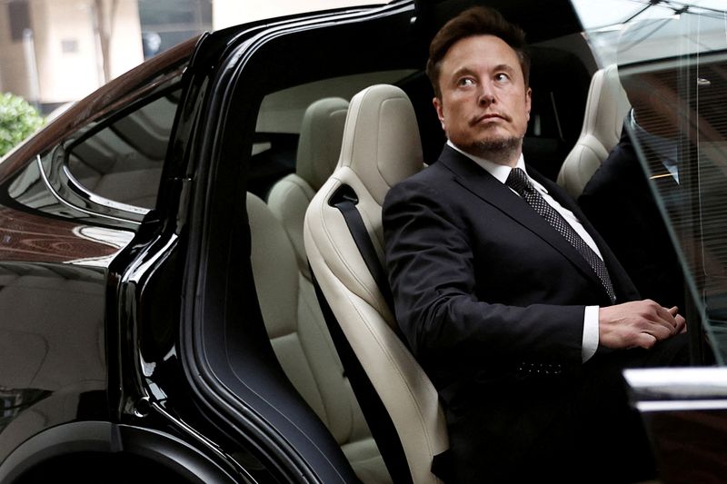 FILE PHOTO: Tesla Chief Executive Officer Elon Musk gets in a Tesla car as he leaves a hotel in Beijing, China May 31, 2023. REUTERS/Tingshu Wang/File Photo