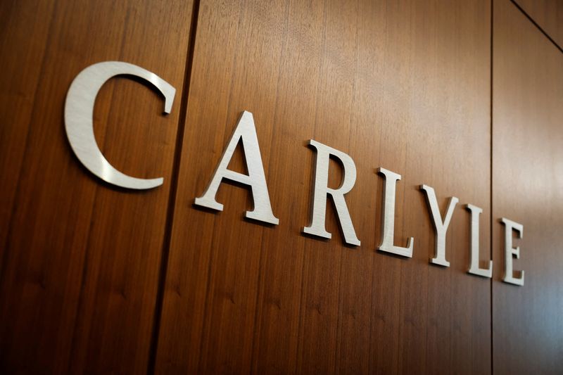 FILE PHOTO: Carlyle signage displays at the office in Manhattan in New York City, U.S., February 26, 2025. REUTERS/Jeenah Moon/File Photo