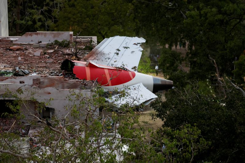 FILE PHOTO: FILE PHOTO: Tail of an Air India Boeing 787 Dreamliner plane that crashed is seen stuck on a building after the incident in Ahmedabad, India, June 12, 2025. REUTERS/Amit Dave/File Photo